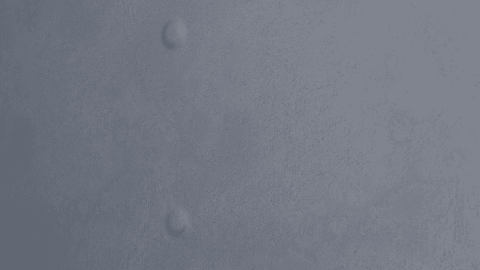 Illustration of a close-up detail of a nail pop defect on a textured gray drywall surface